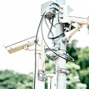 Observation cameras on a column in the city park. Copy space in upper left part